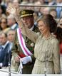Spains King Juan Carlos and Queen Sofia stand above the Spanish Royal seal as they preside over a military parade to mark Armed Forces Day in Valladolid