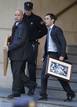 Spanish judge Baltasar Garzons assistants carry two pictures belonging to him outside the Spains High Court in Madrid