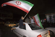 Supporters of Iranian presidential candidate Mahmoud Ahmadinejad celebrate in Tehran after preliminary results showed him leading