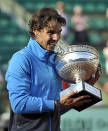 El tenista espa&ntilde;ol Rafael Nadal muerde su trofeo tras vencer al suizo Roger Federer en la final del torneo de Roland Garros en Par&iacute;s. Nadal ha conseguido su sexto Roland Garros e igual al sueco Bj&ouml;rn Borg.