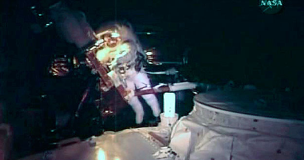 Astronaut John Grunsfeld is seen in the payload bay of the space shuttle as he prepares to work on the Hubble Space Telescope Astronaut John Grunsfeld is seen in the payload bay of the space shuttle as he prepares to work on the Hubble Space Telescope