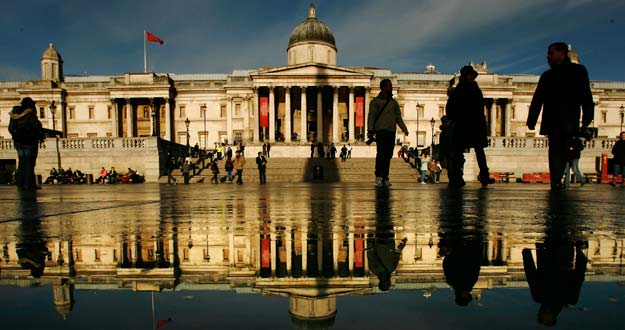 The National Gallery is reflected in surface water in Trafalgar Square in London The National Gallery is reflected in surface water in Trafalgar Square in London