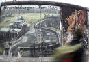 Tourist walks along the East Side Gallery in Berlin