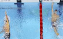 Tyler Clary of the U.S. swims to win gold ahead of third-placed Ryan Lochte of the U.S. in the men's 200m backstroke final during the London 2012 Olympic Games at the Aquatics Centre