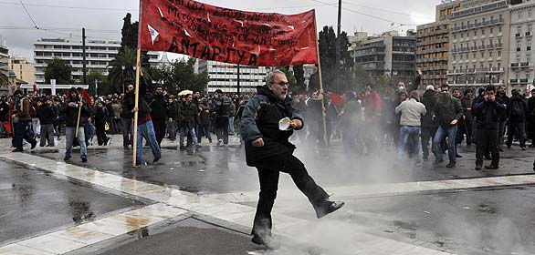 Uno de los manifestantes devuelve un bote de gas lacrimógeno lanzado por la policía a los agentes Uno de los manifestantes devuelve un bote de gas lacrimógeno lanzado por la policía a los agentes