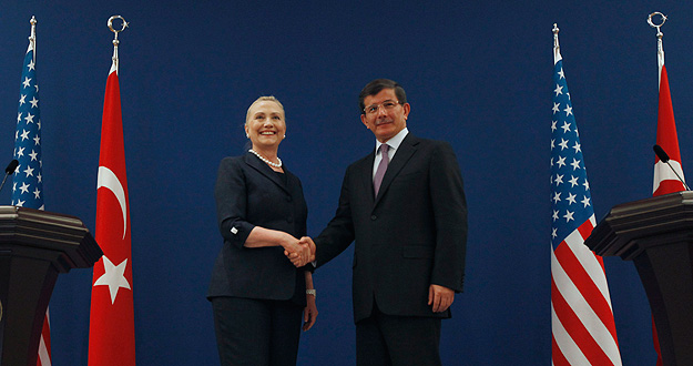 U.S. Secretary of State Clinton and Turkish Foreign Minister Davutoglu pose for the media after their news conference