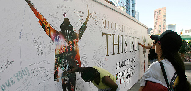 A woman signs a tribute wall for Michael Jackson at the L.A. Live complex