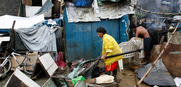 Vecinos limpian sus chabolas tras el paso del tif&oacute;n Nesat en Marikina, Filipinas