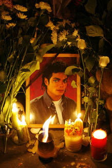 Candles are placed in front of the portrait of pop star Michael Jackson at the U.S. embassy in Moscow Candles are placed in front of the portrait of pop star Michael Jackson at the U.S. embassy in Moscow
