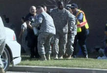 Video grab of emergency personnel carrying wounded at the U.S. Army post at Fort Hood, Texas