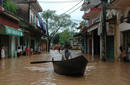 A resident pushes a boat along flooded road in Vietnams northern Bac Giang province