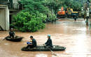 Residents row boats along flooded road in Vietnams northern Quang Ninh province