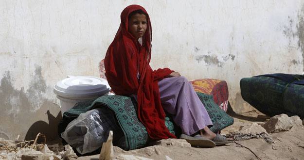 A girl, fleeing a military offensive in South Waziristan, sits on her family's belongings in Dera Ismail Khan A girl, fleeing a military offensive in South Waziristan, sits on her family's belongings in Dera Ismail Khan