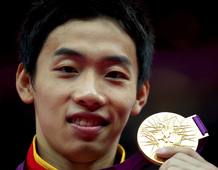 Zou Kai of China celebrates with his gold medal in the men's gymnastics floor exercise victory ceremony in the North Greenwich Arena during the London 2012 Olympic Games